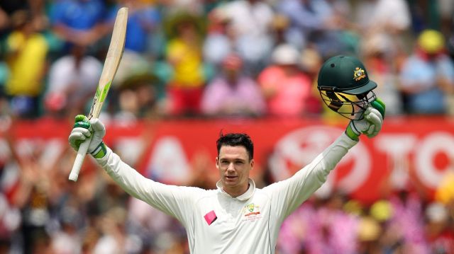 Milestone: Handscomb salutes the crowd after reaching three figures.