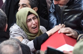 Family and friends of Fatih Cakmak, a security guard killed in the Istanbul nightclub attack, mourn during his funeral ...