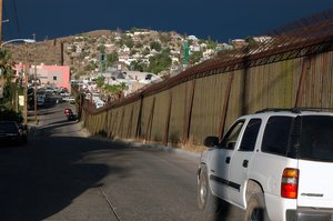  A fence runs along the U.S. border with Mexico in Nogales, Ariz., on June 21, 2006. 