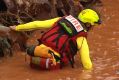 Emergency workers search for a man who went missing in flood waters at Tolga,?west of Cairns.