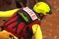 Emergency workers search for a man who went missing in flood waters at Tolga, west of Cairns.