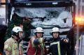 Fire fighters stand in front of a truck which ran into a crowded Christmas market killing several people Monday evening ...