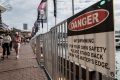 Temporary fencing and signs at Darling Harbour and King Street Wharf before New Year's Eve.