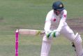 Hit the top: Peter Handscomb clips the leg stump.