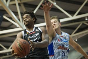 Hang time: Casper Ware launches himself past Adelaide's Daniel Johnson.