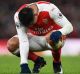 Feeling the strain: Alexis Sanchez goes down on his haunches against Crystal Palace on New Year's Day.