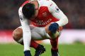 Feeling the strain: Alexis Sanchez goes down on his haunches against Crystal Palace on New Year's Day.