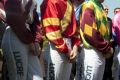 Health and pay fears: Jockeys gather at the winners area at Doomben racecourse to pay their tributes to Tim Bell in ...