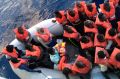 Migrants in a dinghy are rescued by the vessel Burbon Argos, run by Medecins sans Frontieres, in the Mediterranean sea.