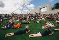 Hundreds roll down the lawns of Parliament House in a protest against plans to fence off the area.