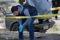 An Egyptian explosives expert looks for evidence at the site of the bomb explosion in Cairo on December 9.