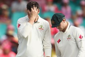 Second knock: Matt Renshaw with Australia skipper Steve Smith after being hit on the helmet while fielding on Thursday.