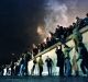 East German citizens climb the Berlin wall at the Brandenburg gate after the opening of the East German border was ...