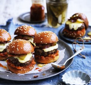 Beef sliders with bacon, cheese and pickles.