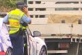 The scene where a truck driver who was pulled over by police on a road in Sydney's west got out of his rig only to be ...