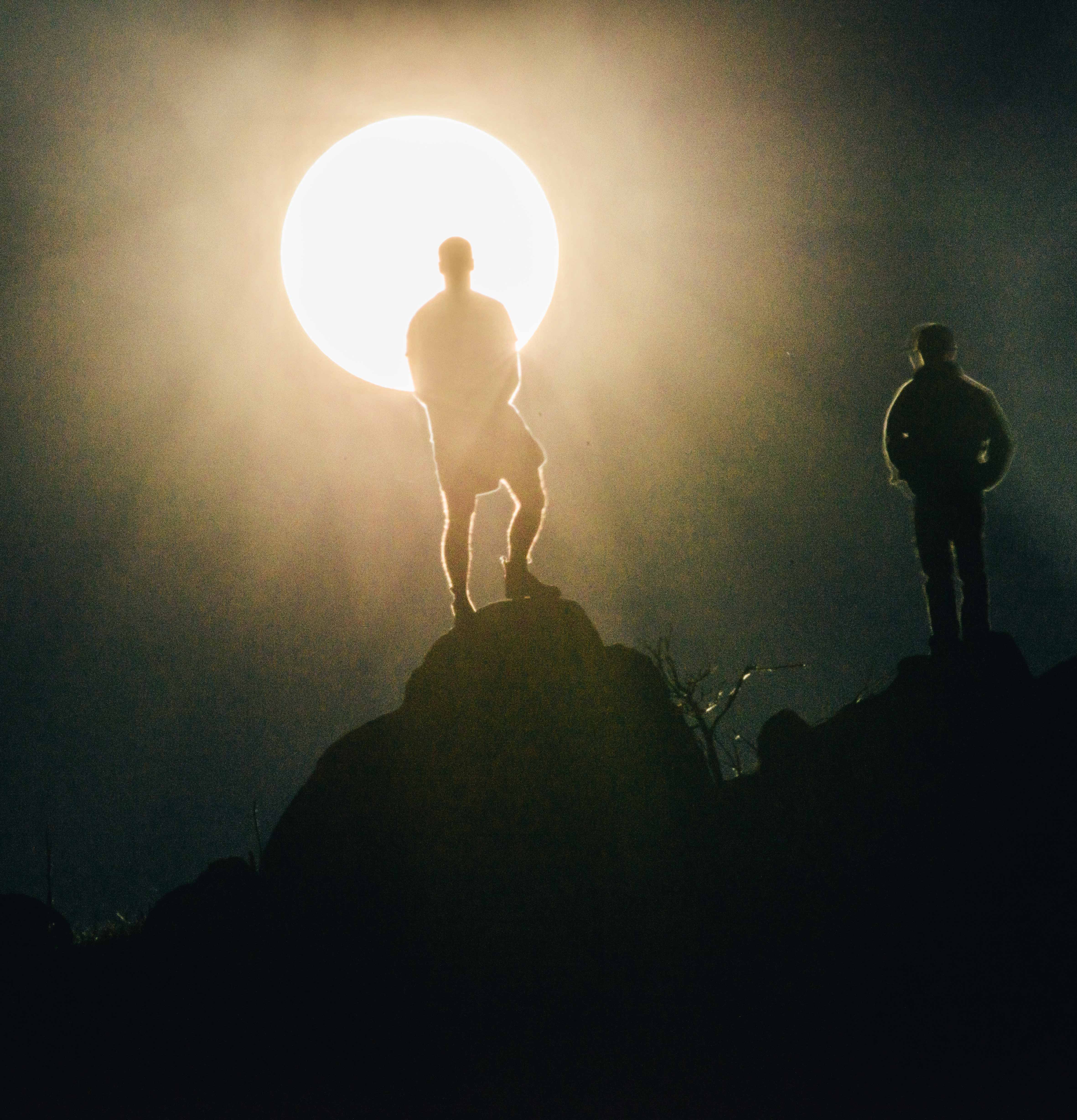 Sheep farmers Gerard Allen and James Ling watch the rising supermoon from Cookanalla farm in Fyshwick.