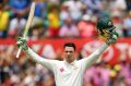 Milestone: Handscomb salutes the crowd after reaching three figures.