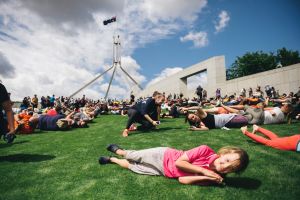 Hundreds roll down the slope of the Parliament House lawns