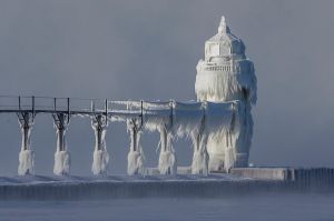 Extreme cold conditions cause ice accretions to cover the St. Joseph lighthouse and pier, on the southeastern shoreline ...