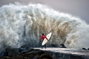 A huge wave crashes against Castlerock pier as professional surfer Al Mennie waits on a break in the swell in Coleraine, ...