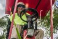 Mower operators work extra hard to cut long grass over the summer months in Canberra.