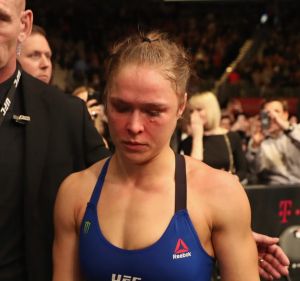 Bloodied and beaten: Ronda Rousey leaves the Octagon after her loss last weekend.