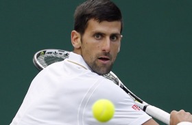 Novak Djokovic of Serbia returns to Sam Querrey of the U.S during their men's singles match on day six of the Wimbledon ...