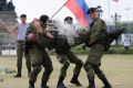 A Russian Marine uses a hammer to break a brick on top of his comrade's stomach during a Capability Demonstration at ...