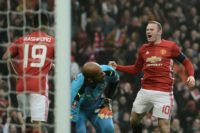 Wayne Rooney (right) celebrates after equalling Bobby Charlton's Manchester United all-time scoring record during the English FA Cup third round match against Reading at Old Trafford on January 7, 2017