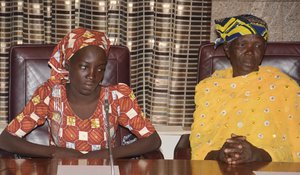 In this Thursday, May. 19, 2016 file photo, Amina Ali, left, the first rescued Chibok schoolgirl, and her mother, Binta Ali Nkeki attend a meeting with Nigeria's President Muhammadu Buhari at the Presidential palace in Abuja, Nigeria.