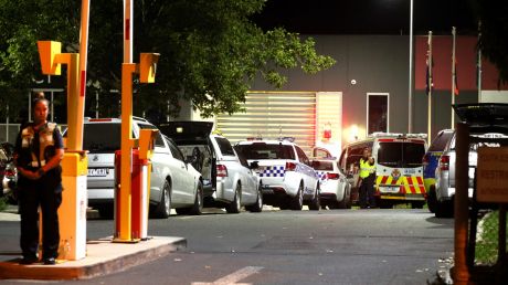 Police vehicles at Melbourne Youth Justice Centre in Parkville late Saturday night.