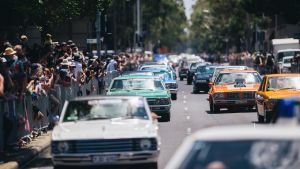 Crowds watch the Summernats 'City Cruise' pass through Canberra on Thursday.