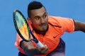 Promise: Nick Kyrgios will play in Monday night's Fast4 exhibition tournament despite struggling with a knee injury.