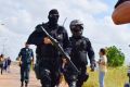 Heavily armed police officers walk outside the Agricultural Penitentiary of Monte Cristo, after dozens of inmates were ...