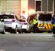 Police vehicles at Melbourne Youth Justice Centre in Parkville late on Saturday night.