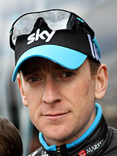 Bradley Wiggins wearing a black cap with the word "SKY" written on it.