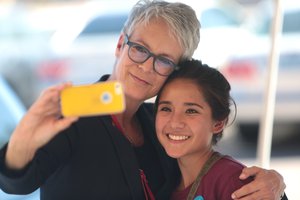 Jamie Lee Curtis taking selfie with smartphone with a supporter, Tempe, Arizona