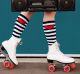 Legs of woman wearing white roller skates with red wheels, holding radio. Get your skates on for the Sydney Festival ...