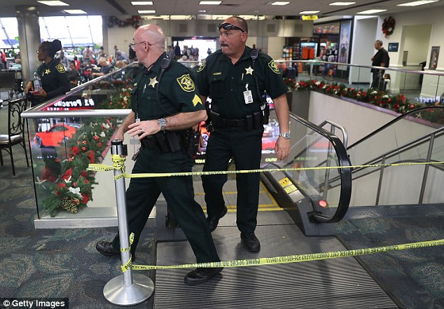 Things are beginning to go back to normal at the Fort Lauderdale airport less than 48 hours after a gunman opened fire inside a crowded baggage claim area. Pictured are two police officers at the airport on Saturday morning