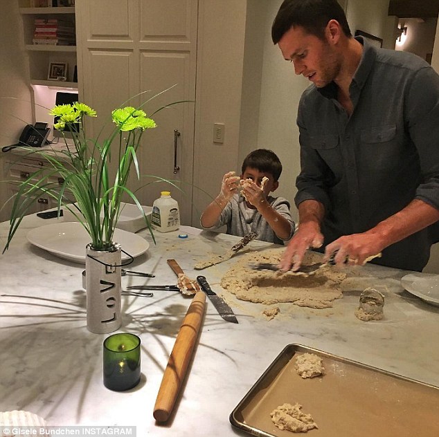 Doting dad: Tom has also appeared on her feed multiple times, usually interacting with their two children, Vivian Lake Brady, aged four, or Benjamin Brady, aged nine (pictured)