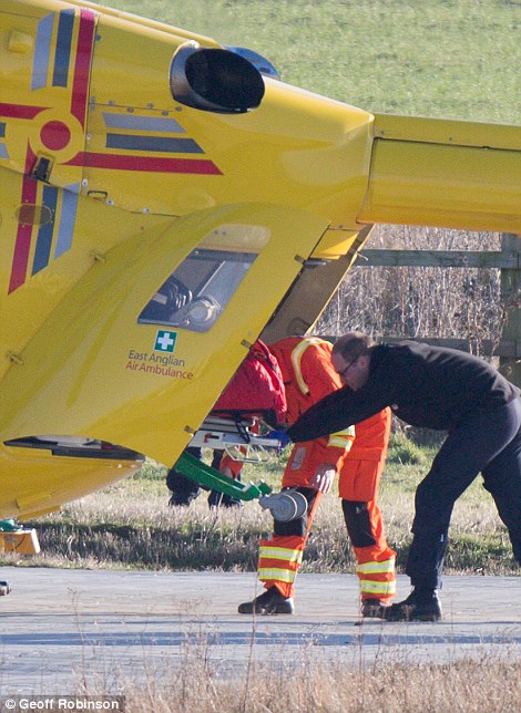 Prince William, who was dressed head-to-toe in black, showed his strength as he hauled the stretcher off the helicopter