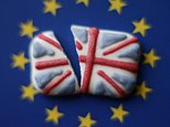 A broken Union flag cake decoration placed on the backdrop of the European flag.