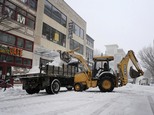 Road crews clear the street during a snowstorm on Saturday, Jan. 7, 2016 in Norfolk, Va.  Snow pounded a swath of Virginia on Saturday as hundreds crashed on...