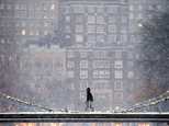 A person crosses the pedestrian bridge in the Public Garden during a winter storm in Boston, Saturday, Jan. 7, 2017. (AP Photo/Michael Dwyer)