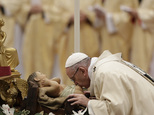 Pope Francis kisses a statue of the Divine Infant as he celebrates an Epiphany Mass in St. Peter's Basilica at the Vatican, Friday, Jan. 6, 2017. (AP Photo/A...