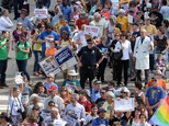 FILE - In this April 25, 2016 file photo, protesters head to the legislative building in Raleigh, N.C., for a sit-in against House Bill 2, a contentious law ...