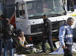 Israeli police investigates the scene of an attack in Jerusalem Sunday, Jan. 8, 2017. A Palestinian rammed his truck into a group of Israeli soldiers in Jeru...