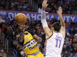 Denver Nuggets guard Emmanuel Mudiay (0) passes around Oklahoma City Thunder center Enes Kanter (11) in the first half of an NBA basketball game in Oklahoma ...