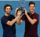 Unexpected victory: Jordan Thompson and Thanasi Kokkinakis hold the winners trophy on day eight of the Brisbane ...