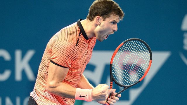 BRISBANE, AUSTRALIA - JANUARY 08: Grigor Dimitrov of Bulgaria celebrates winning the first set against Kei Nishikori of ...